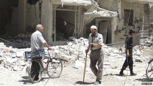 Residents view damage in a Damascus suburb