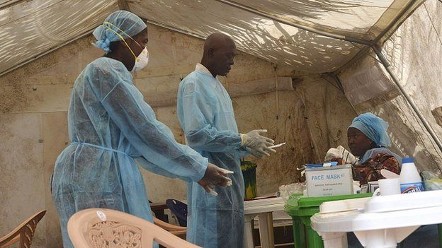 Health workers take blood samples for Ebola virus testing at a screening tent in Kenema, Sierra Leone. 30 June 2014