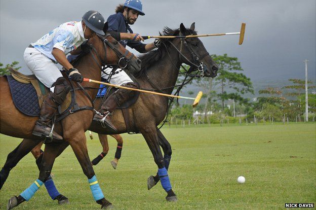 Two competitors challenge each other for the ball during a polo match in Jamaica - June 2014