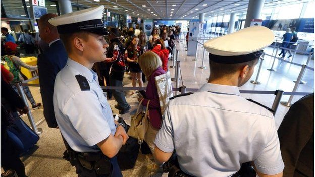 Police officers patrol at a security gate inside the main terminal of Frankfurt Airport July 3