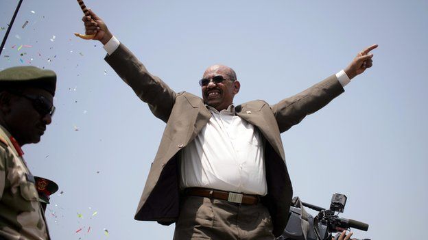 Sudanese President Omar al-Bashir waves to the crowd as he attends for the inauguration of the White Nile Sugar factory near the Al-Dewaim city in the state of the White Nile on 11 July 2012