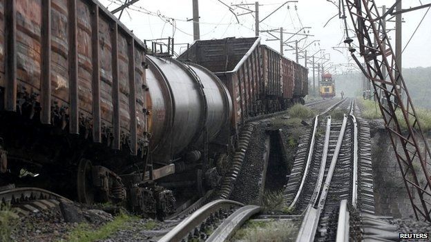 A train stands on a destroyed railroad bridge which fell over a main road leading to the eastern Ukrainian city of Donetsk, near the village of Novobakhmutivka - 7 July 2014