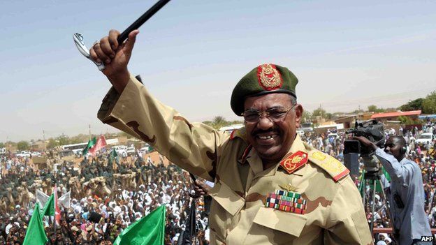 Sudanese President Omar al-Bashir waves to the crowd during his visit to the Northern Kordofan town of El-Obeid to address a rally of freshly-trained paramilitary troops on 19 April 2012