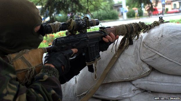 A pro-Russian militant manning a checkpoint in Donetsk on 8 July 2014.