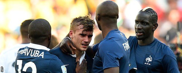 Antoine Griezmann is comforted by his team-mates following France's elimination from the 2014 World Cup