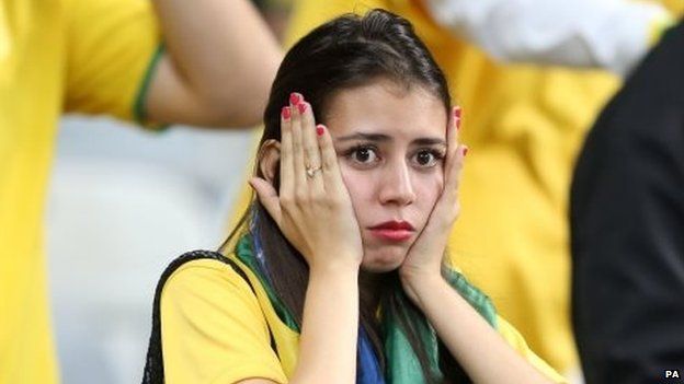 A Brazilian fan reacts during the match