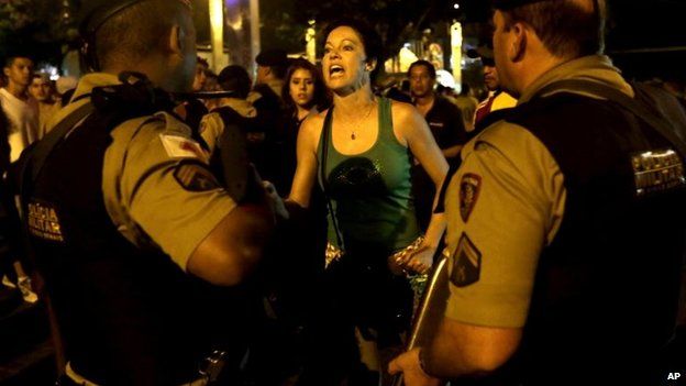 A female Brazilian supporter shouts insults at the police