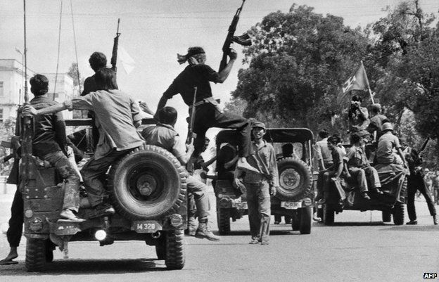 Khmer Rouge guerrilla soldiers drive through a street in Phnom Penh on 7 April 1975 - the day Cambodia fell under the control of the Communist Khmer Rouge's forces.