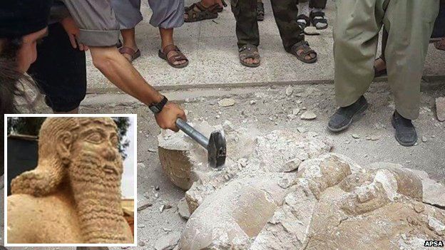 Isis fighters destroying a statue