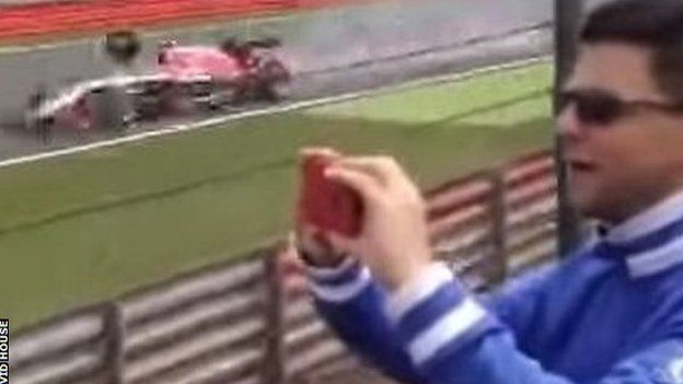 A tyre from Kimi Raikkonen's Ferrari narrowly misses Max Chilton's Marussia at Silverstone