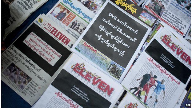 Newspapers with a black front page are displayed at a stall in Yangon on April 11, 2014, after Zaw Pe, a journalist for the Democratic Voice of Burma (DVB) news website, was convicted of trespassing and 'disturbing a civil servant' by a court in the central town of Magway on 7 April.