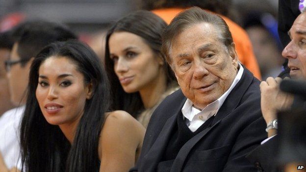 LA Clippers owner Donald Sterling (right) and V. Stiviano (left) watch the team play in LA on 25 October 2013