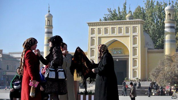 This picture taken on 8 November 2013 shows a group of Uighur women outside a mosque in Kashgar, far west China's Xinjiang region.