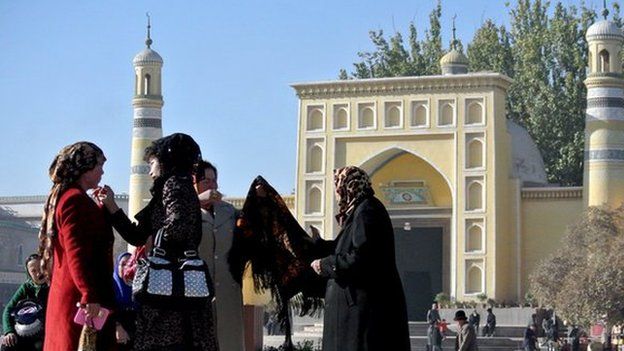 This picture taken on 8 November 2013 shows a group of Uighur women outside a mosque in Kashgar, farwest China's Xinjiang region.