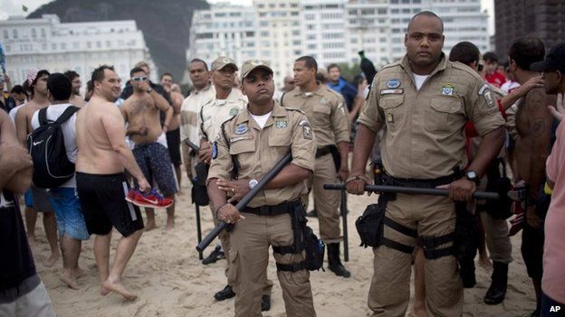 Police stand guard as Argentina soccer fans gather on Copacabana beach during the World Cup in Rio de Janeiro, Brazil, 11 July 2014