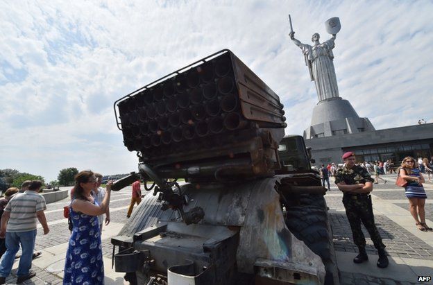 Ukrainian soldiers in Kiev show off a rocket system said to have been captured from the rebels, 12 July