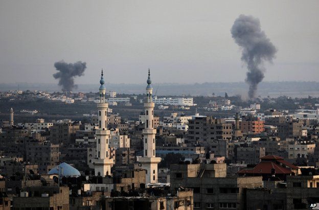 Columns of smoke rise above Gaza City after Israeli air strikes, 12 July