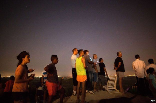 Israelis watch the fighting in Gaza from near Sderot, 12 July