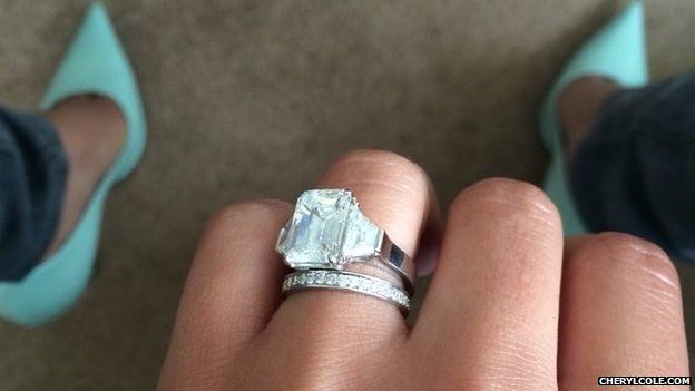 A picture posted on Cheryl Cole's website showing a hand wearing engagement and wedding rings
