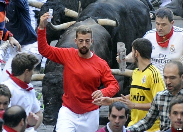 Man takes a selfie during the Pamplona bull run