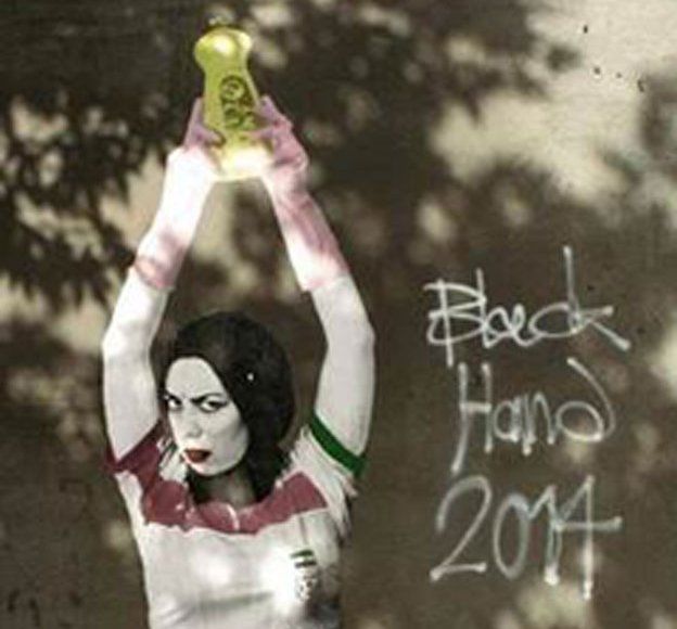 A piece of graffiti in Iran that's been widely shared, which shows a woman in an Iranian national shirt who is holding up a bottle of washing up liquid