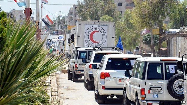 Red Crescent Society delivering shipment of UN food aid to Moaddamiet al-Sham area on outskirts of Damascus. 14 July 2014