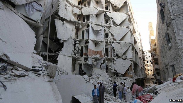 Buildings in Aleppo hit by what activists said was a barrel bomb. 14 July 2014