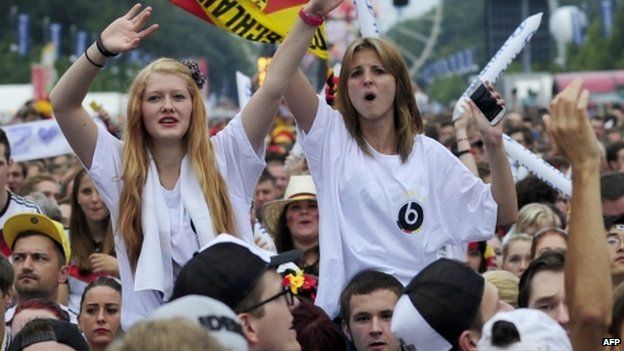 German fans gather in front of a stage installed for a victory parade of the national football team at Berlin's landmark Brandenburg Gate (15 July 2014)