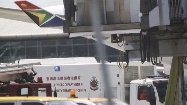 Fire service vehicle parks in front of the South African Airways flight SA286 in the Hong Kong International Airport, 16 July 2014