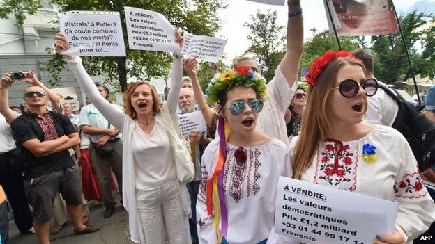 Protesters in Kiev denounce the sale of Mistral-class warships to Russia outside the French ambassador's house in Kiev