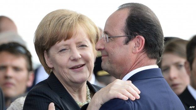 French President Francois Hollande (R) embraces German Chancellor Angela Merkel at the international D-Day commemoration ceremony in Ouistreham (June 2014)
