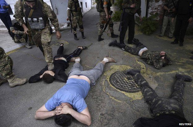 Azov fighters guarding suspected rebels in Mariupol, eastern Ukraine, 13 June