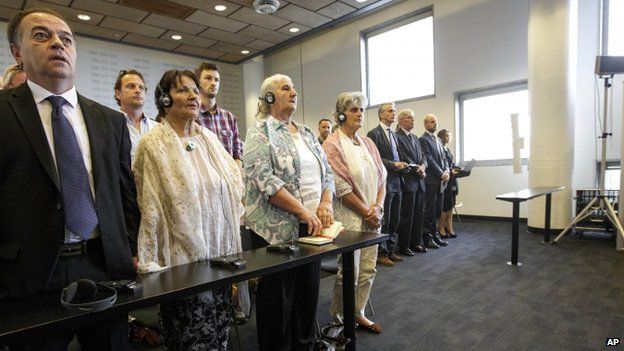 Women from the Bosnian town of Srebrenica stand as judges enter a civil court in The Hague, Netherlands, on Wednesday 16 July 2014