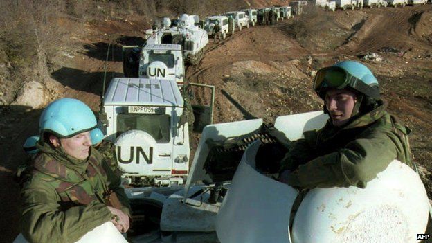 Dutch soldiers riding on an armoured vehicle accompanying a Dutch-UN convoy of 56 engineering vehicles on their way to Lukavac in Bosnia-Hercegovina (February 1994)
