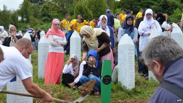 Bosnian Muslims, family members and survivors of the Srebrenica 1995 massacre, attend the burial ceremony at a memorial cemetery in Potocari near Srebrenica (11 July, 2014)