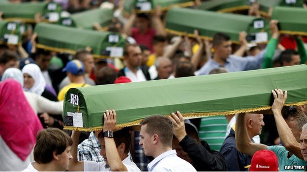 Bosnian Muslims carry coffins during the mass funeral of 175 newly-identified victims from the 1995 Srebrenica massacre, in Potocari Memorial Center, near Srebrenica (11 July, 2014)