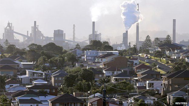 In this Wednesday, July 2, 2014 photo, smoke billows out of a chiming chimney stack of a steel works factories in Port Kembla 86 kilometers (53 miles) south of Sydney