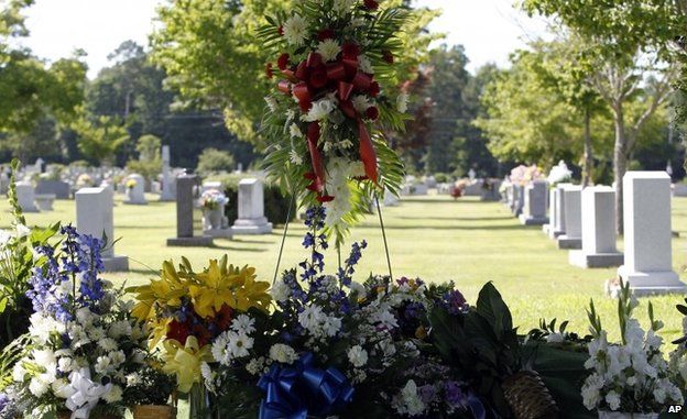 Flowers cover the grave of Cooper Harris in Tuscaloosa, Alabama