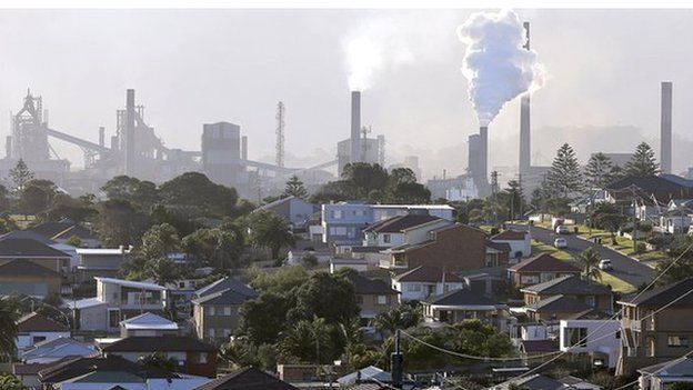 In this Wednesday, July 2, 2014 photo, smoke billows out of a chiming chimney stack of a steel works factories in Port Kembla 86 kilometers (53 miles) south of Sydney