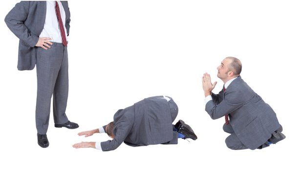 man in a suit bowing down