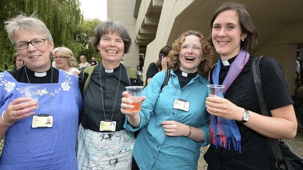 Women clergy celebrating after CofE general synod voted to allow women bishops. The one on the rights is Rev Kat Campion-Spall