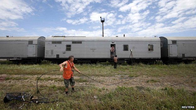 Railway employees work near refrigerator wagons in Torez carrying the bodies of victims of the plane crash - 20 July 2014