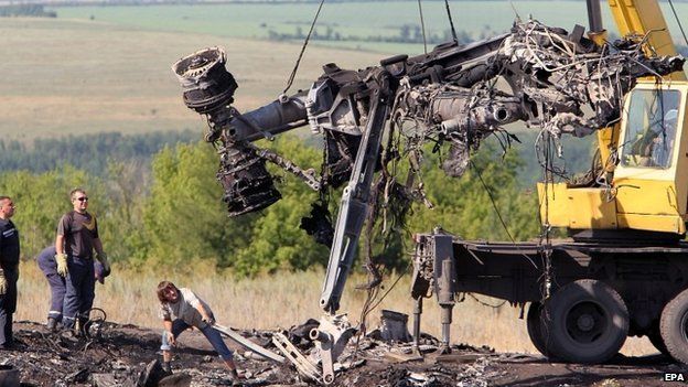 Ukrainian workers move debris from the site of the plane crash in eastern Ukraine - 20 July 2014