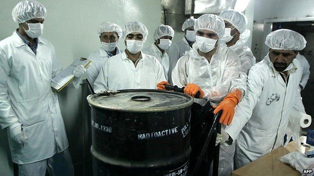 Iranian technicians remove a container of radioactive uranium at the Isfahan Uranium Conversion Facilities south of Tehran - 8 August 2005