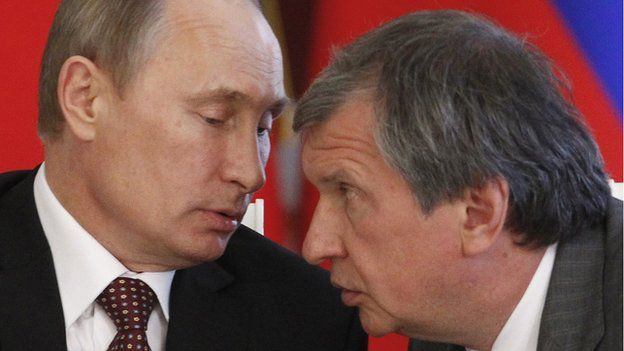 Russian President Vladimir Putin (left) talks to Rosneft President Igor Sechin
