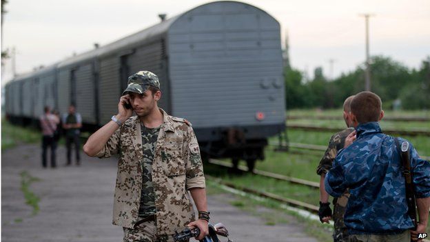 Pro-Russian rebel near train carrying plane crash bodies, Torez, Ukraine (21 July)