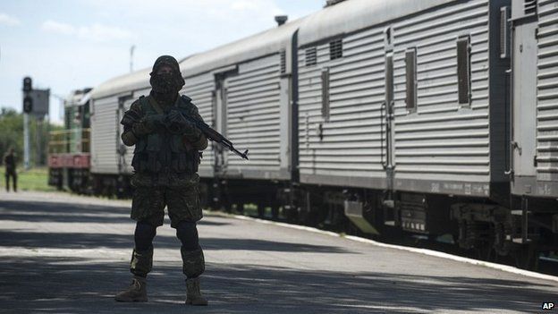 A pro-Russian rebel on patrol next to the freight train loaded with bodies of the passengers at Torez station near the crash site - 21 July 2014
