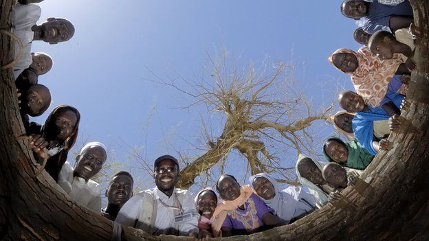 People pictured looking down a well being dug in Khamsa Dagiag camp in Darfur, Sudan - 2007