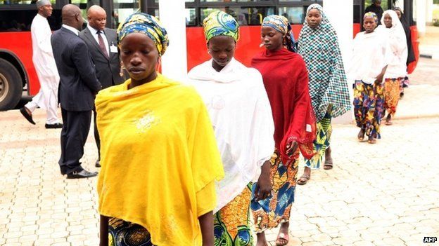 Some of the Chibok schoolgirls who escaped Islamist captors alight from a bus to attend a meeting with Nigerian President Goodluck Jonathan at the presidency in Abuja on 22 July 2014