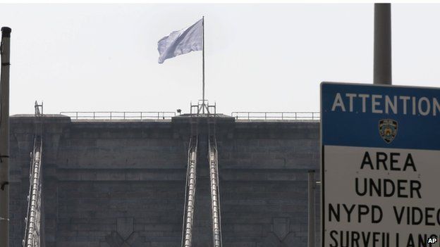 A bleached US flag flies over the Brooklyn Bridge.